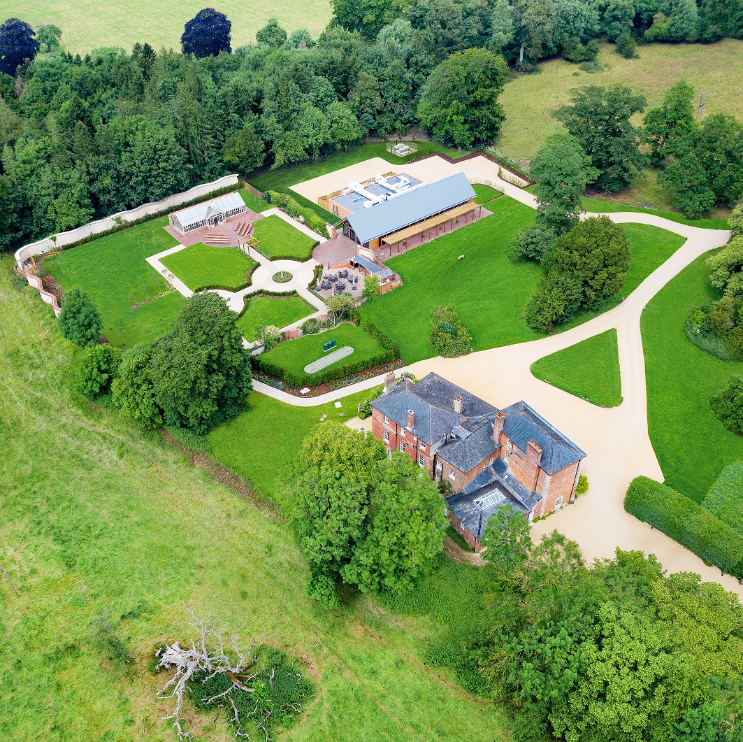 Syrencot Wiltshire near Salisbury Exclusive use secluded bespoke and brand new wedding venue for ceremony and reception aerial view of Syrencot House and estate  